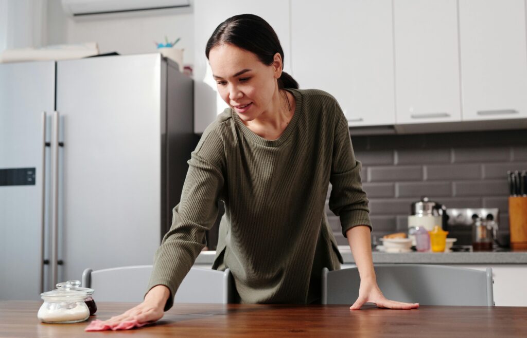 Helppa cleaning down kitchen side.